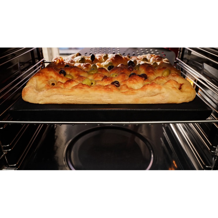 Focaccia baked inside oven taken out with pizza peel 